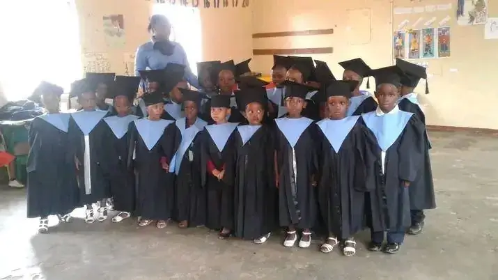 Children in graduation gowns and caps at an early childhood centre